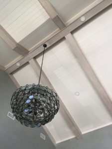 recycled glass chandelier in the shelter cove apartments with interiors by the J Banks Design Group