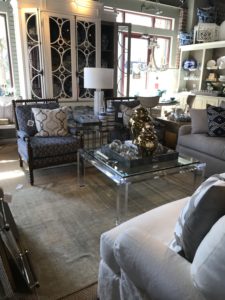 Lucite coffee table in a seating vignette composed by J Banks Design Group